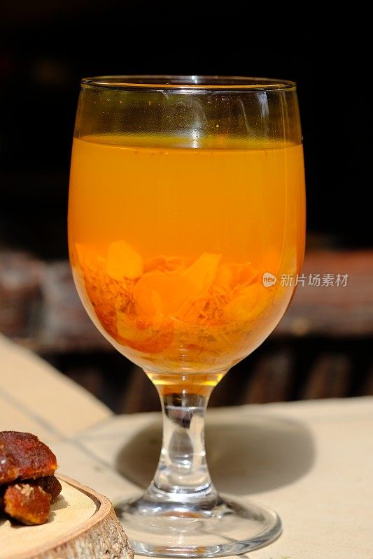 Jamu Kunir Asem是一种传统的爪哇草药饮料，由姜黄、罗望子、红糖和水制成。这种黄色饮料被认为对健康有益，可以增强免疫系统。